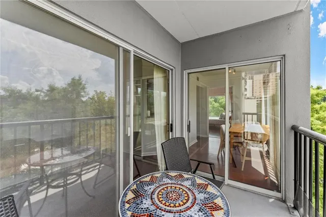 a view of a tall building next to a road