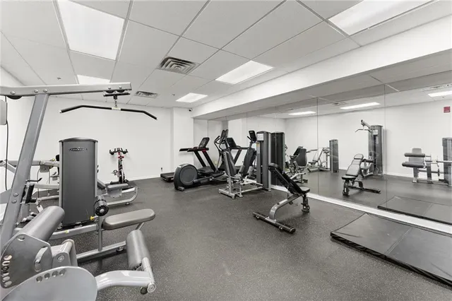 a view of pool with outdoor seating and buildings in the background