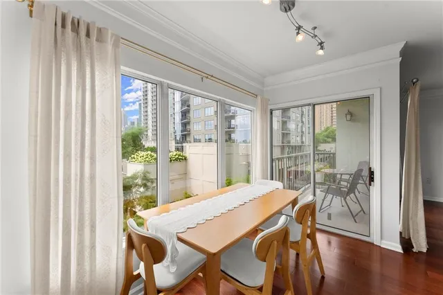 a view of a dining room with furniture window and wooden floor