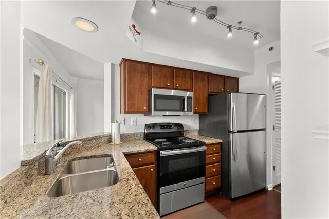 a kitchen with a refrigerator sink and stove