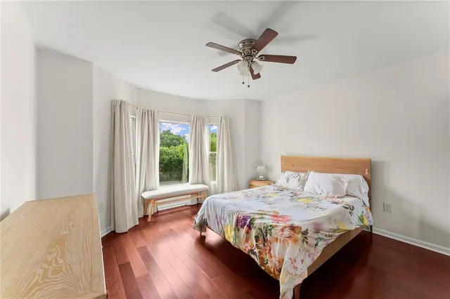 a bedroom with a large bed and a window