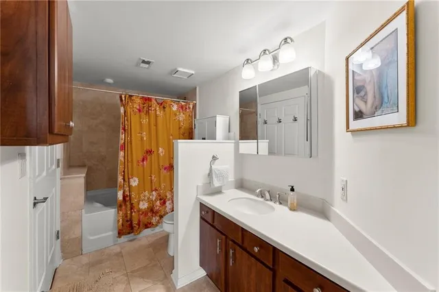 a spacious bathroom with a double vanity sink mirror and shower