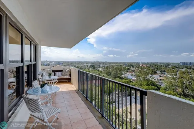 a view of a balcony with chairs