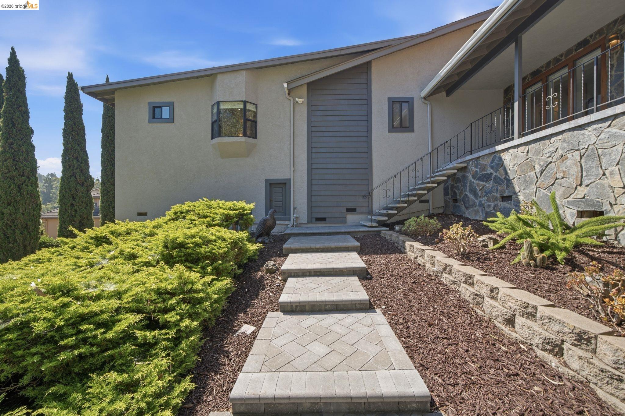11133 Golf Links Road Oakland, CA 94605 - Photo 5 of 57 Entryway featuring paver steps and a stone veneer foundation
