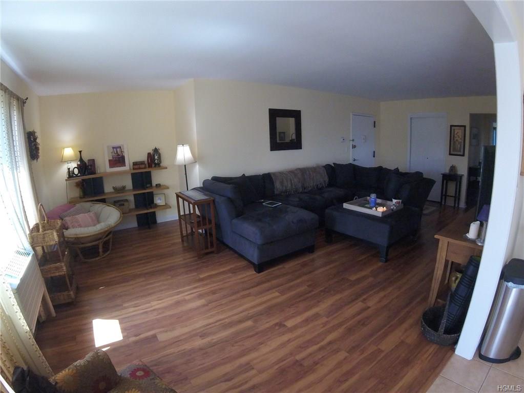 a living room with furniture a flat screen tv and a couch