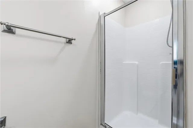 a bathroom with a glass shower door