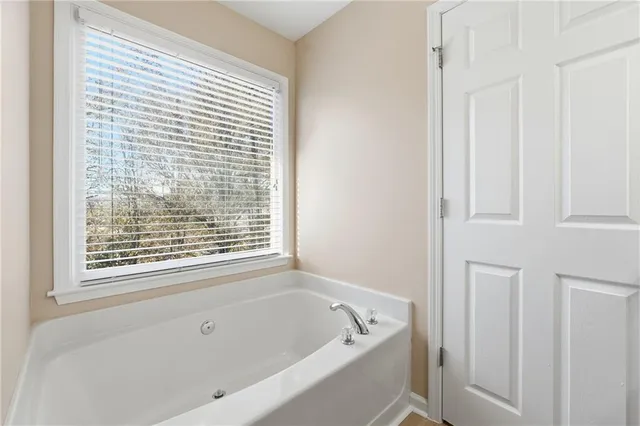 a white bath tub sitting next to a window