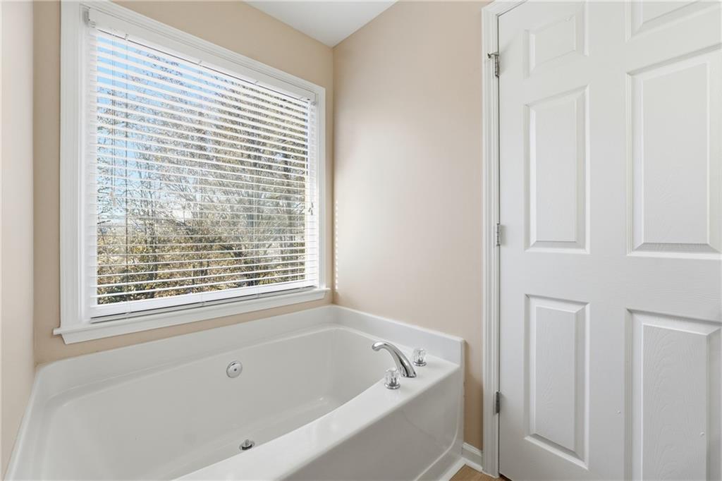 3110 Pittard Hill Point Duluth, GA 30096 - Photo 14 of 24 a white bath tub sitting next to a window