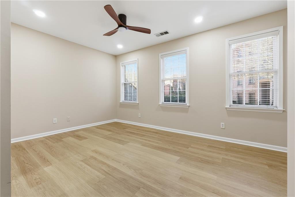 3110 Pittard Hill Point Duluth, GA 30096 - Photo 18 of 24 a view of empty room with wooden floor and fan
