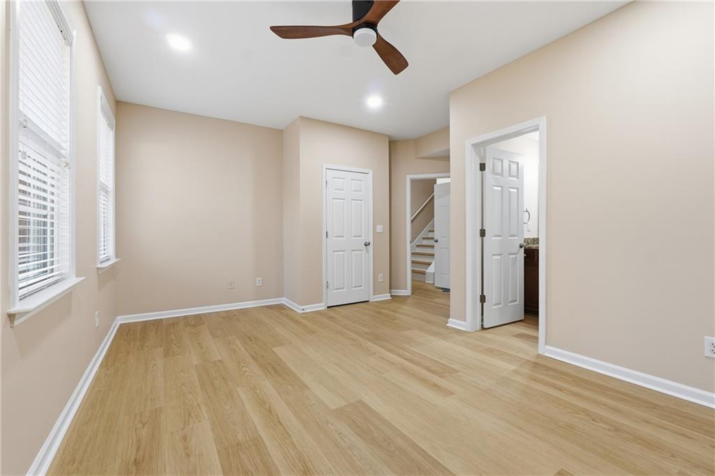 3110 Pittard Hill Point Duluth, GA 30096 - Photo 19 of 24 a view of empty room with wooden floor and fan