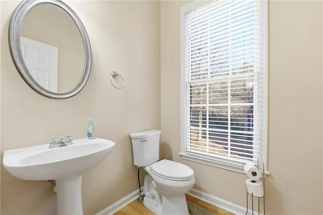 a bathroom with a sink a toilet and a mirror