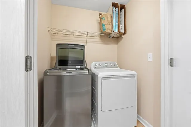 a view of storage and utility room with washer and dryer