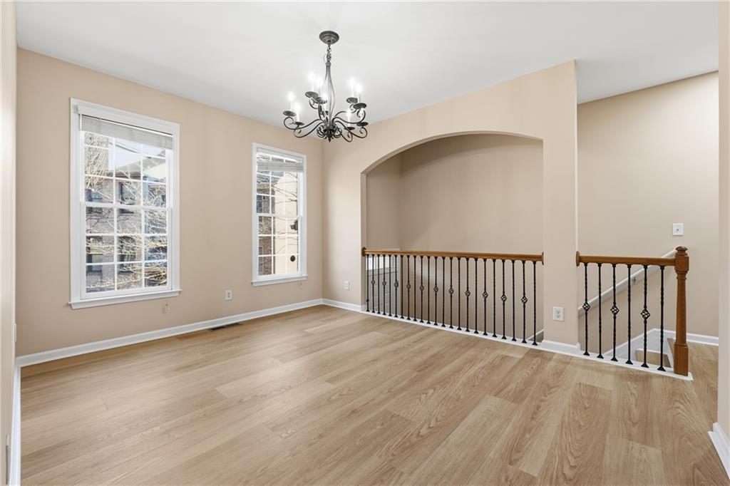 3110 Pittard Hill Point Duluth, GA 30096 - Photo 3 of 24 a view of a livingroom with a chandelier wooden floor and a chandelier
