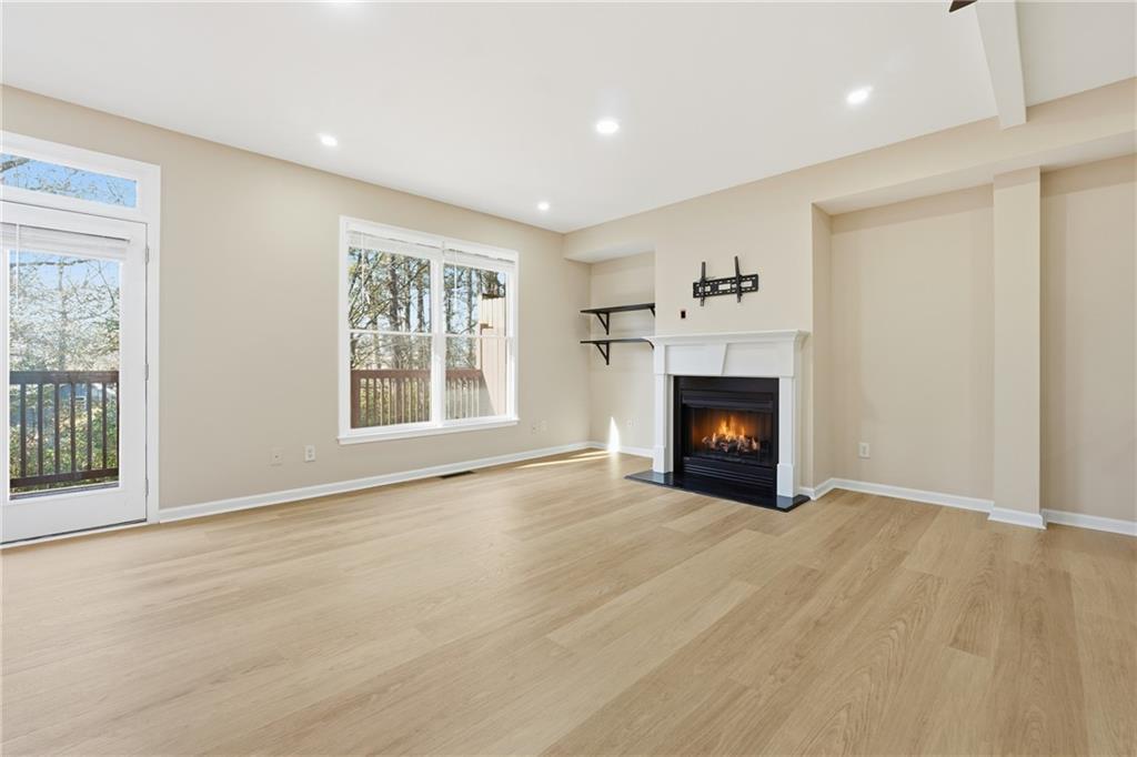 3110 Pittard Hill Point Duluth, GA 30096 - Photo 4 of 24 a view of an empty room with a window and fireplace