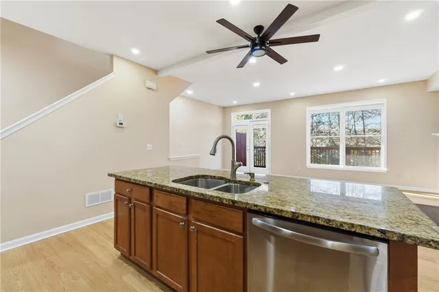 a kitchen with granite countertop a sink and a window