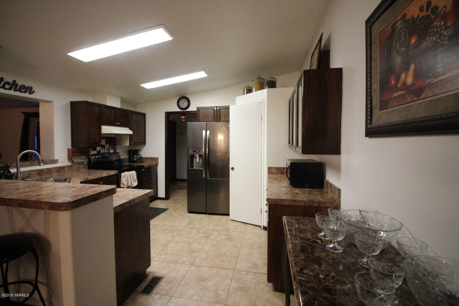 740 Barker Road Granger, WA 98932 - Photo 2 of 19 a kitchen with stainless steel appliances a refrigerator stove and microwave