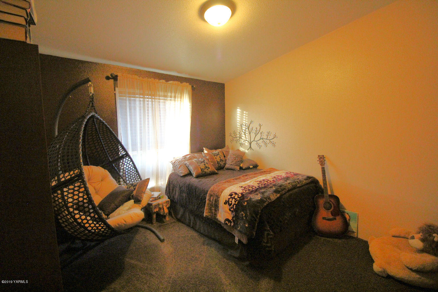 740 Barker Road Granger, WA 98932 - Photo 13 of 19 a bed sitting in a bedroom next to a window