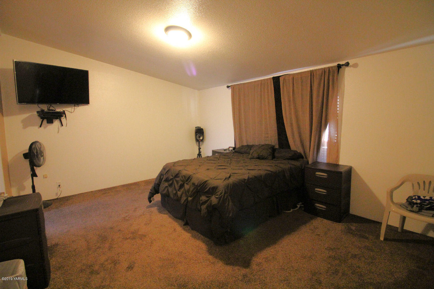 740 Barker Road Granger, WA 98932 - Photo 10 of 19 a bedroom with a bed tv and a window