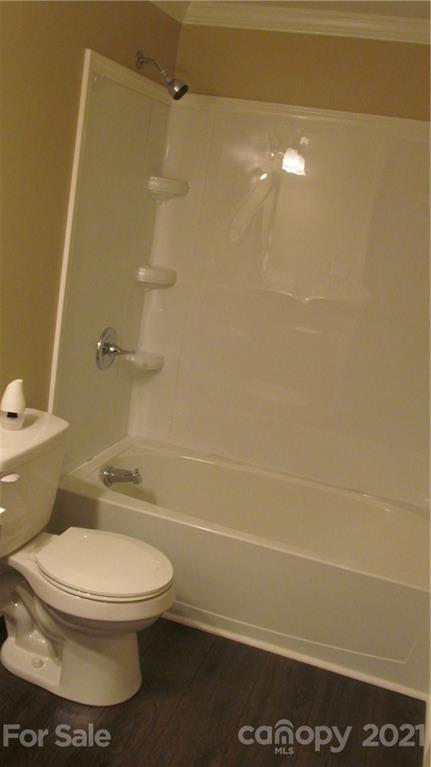 2896 Elbow Road Newton, NC 28658 - Photo 15 of 25 a white toilet sitting next to a bathroom sink and a shower