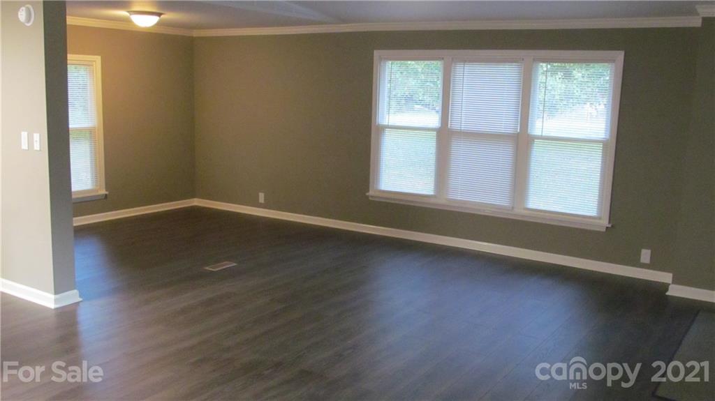 2896 Elbow Road Newton, NC 28658 - Photo 5 of 25 an empty room with wooden floor and windows