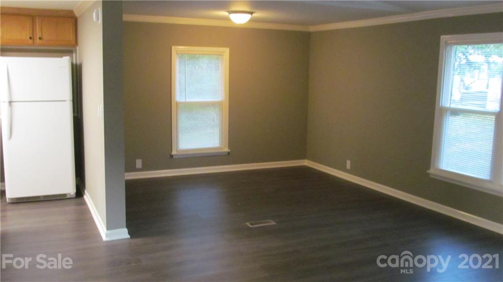 2896 Elbow Road Newton, NC 28658 - Photo 6 of 25 a view of an empty room with wooden floor and a window