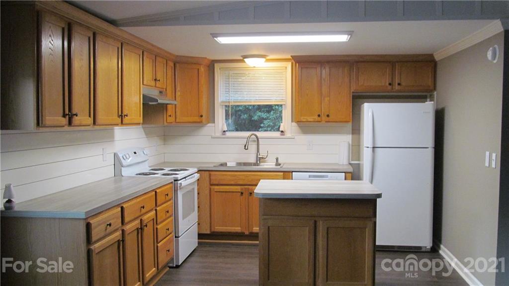 2896 Elbow Road Newton, NC 28658 - Photo 8 of 25 a kitchen with stainless steel appliances granite countertop a sink stove and refrigerator