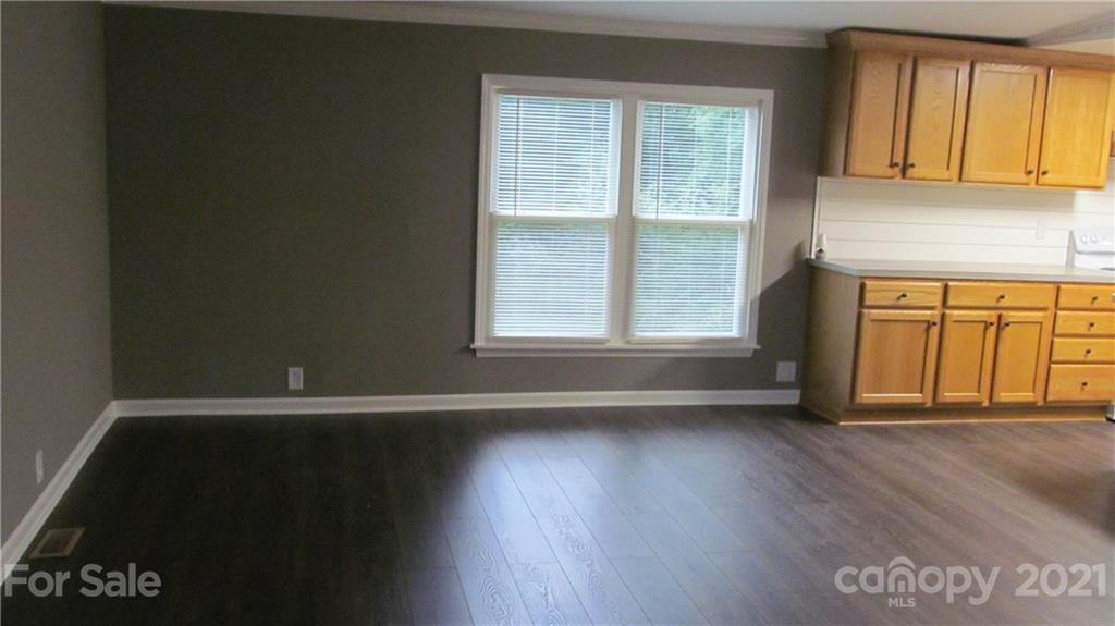 2896 Elbow Road Newton, NC 28658 - Photo 9 of 25 an empty room with wooden floor and windows