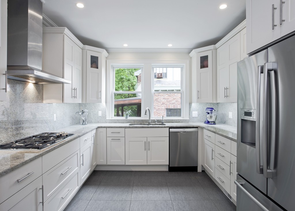 69 University Road, Unit 2 Brookline, MA 02445 - Photo 14 of 29 a kitchen with white cabinets and white appliances