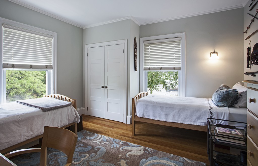 69 University Road, Unit 2 Brookline, MA 02445 - Photo 19 of 29 a bedroom with a bed and large windows