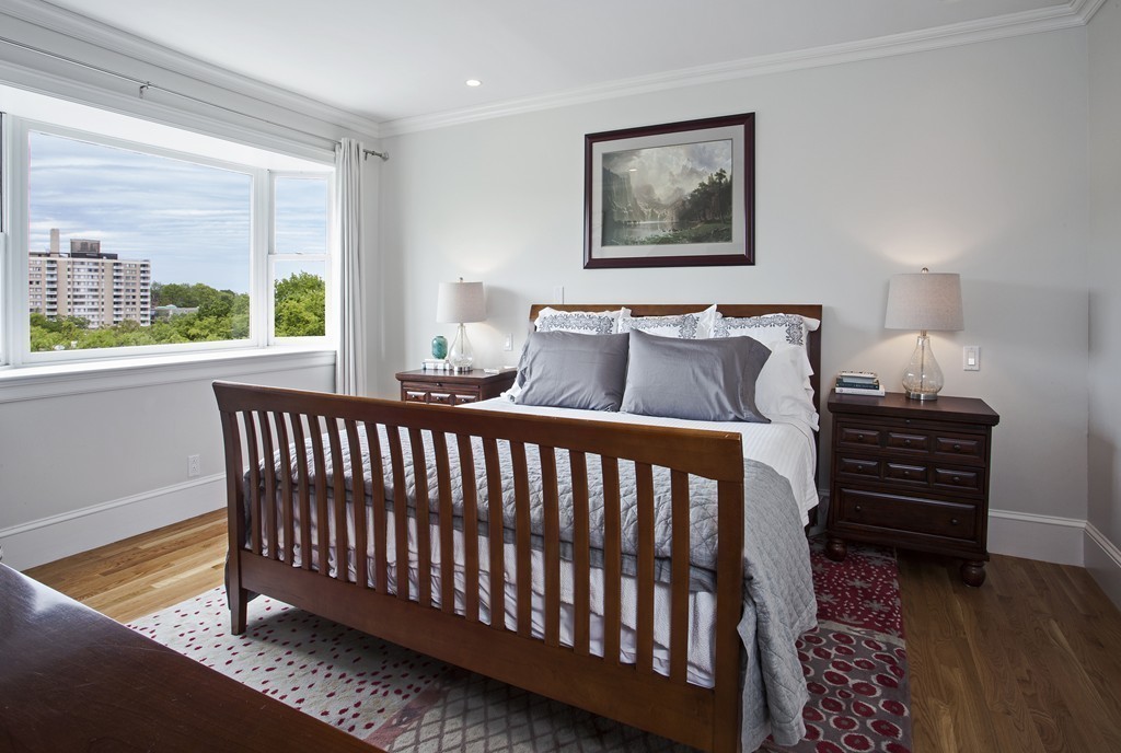 69 University Road, Unit 2 Brookline, MA 02445 - Photo 21 of 29 a bedroom with a bed and wooden floor