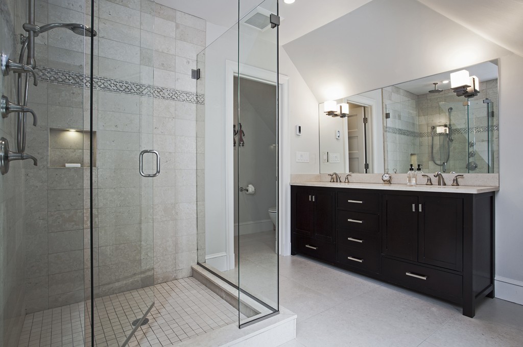 69 University Road, Unit 2 Brookline, MA 02445 - Photo 22 of 29 a bathroom with a double vanity sink shower and mirror