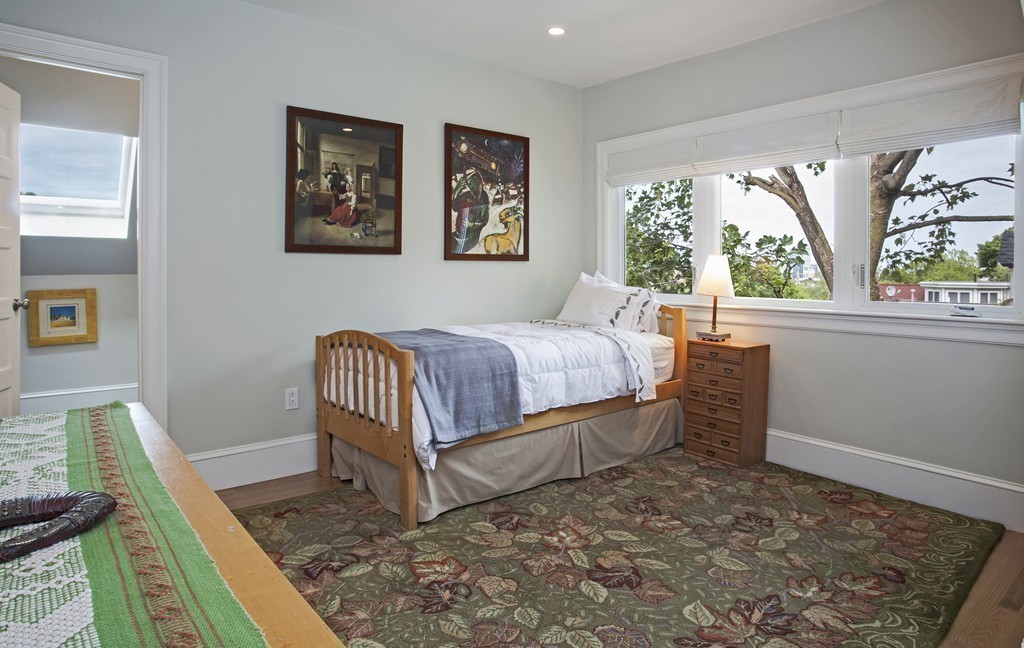 69 University Road, Unit 2 Brookline, MA 02445 - Photo 24 of 29 a bedroom with a bed and a window