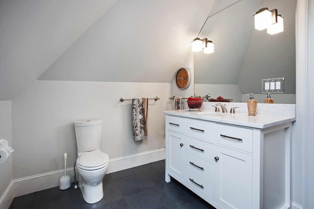 69 University Road, Unit 2 Brookline, MA 02445 - Photo 27 of 29 a bathroom with a sink mirror and toilet