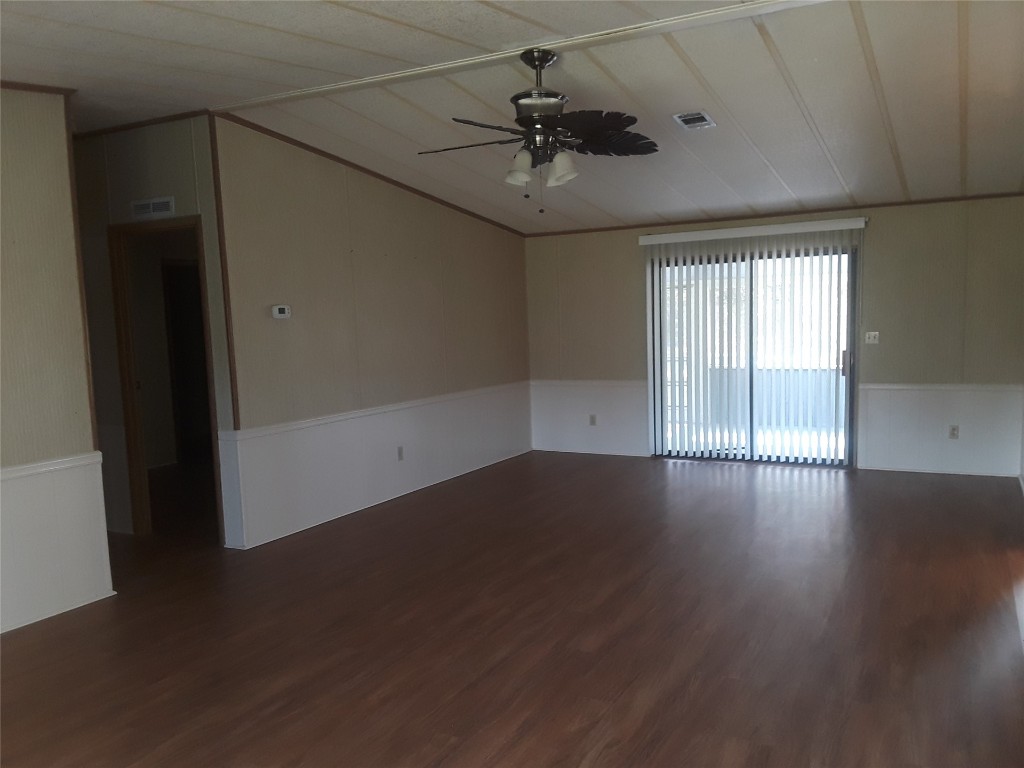 85112 Phillips Road Yulee, FL 32097 - Photo 3 of 17 an empty room with wooden floor and windows