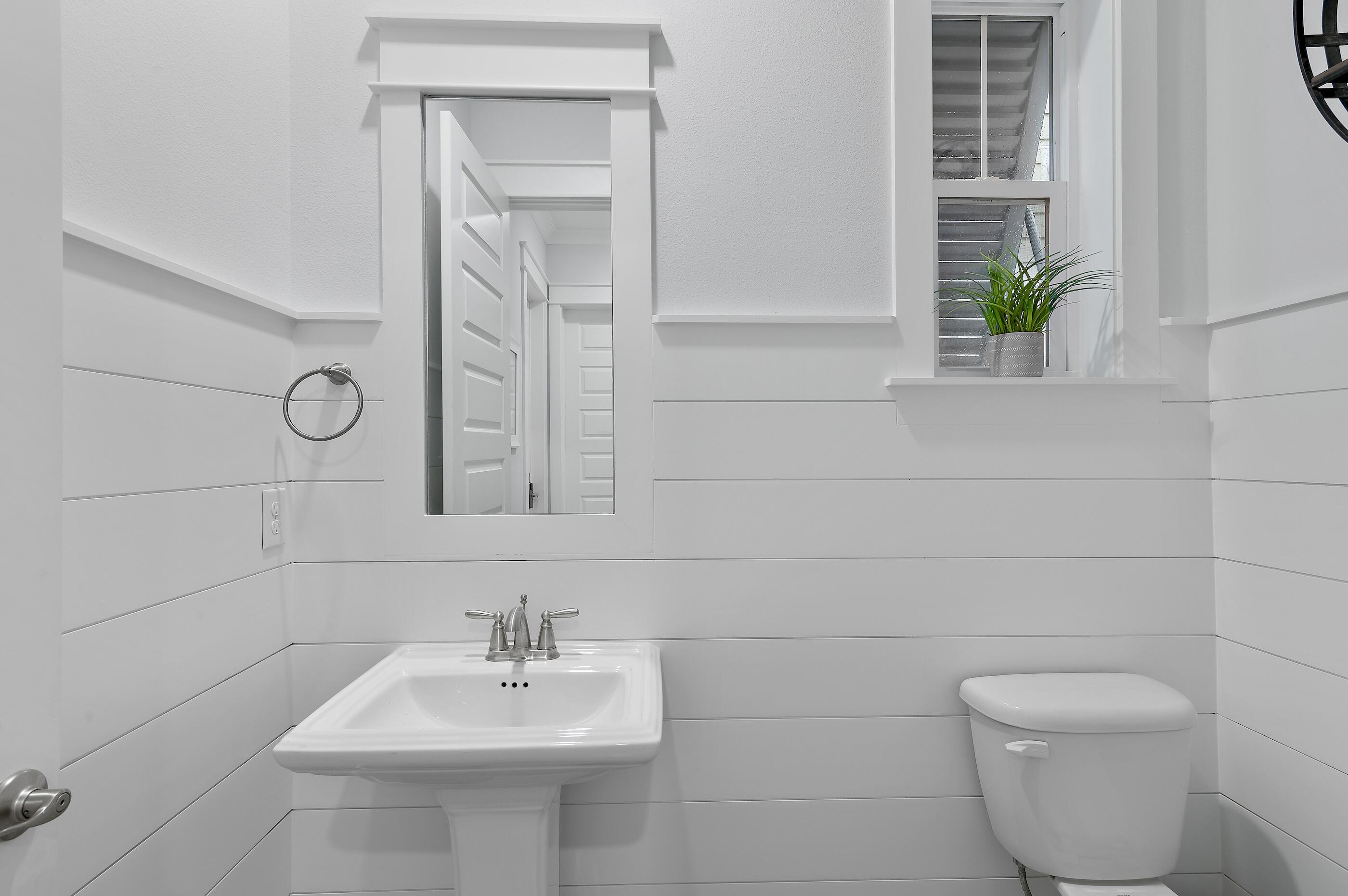 38 Pine Lands Loop East, Unit A Inlet Beach, FL 32461 - Photo 12 of 25 a bathroom with a sink a toilet and mirror