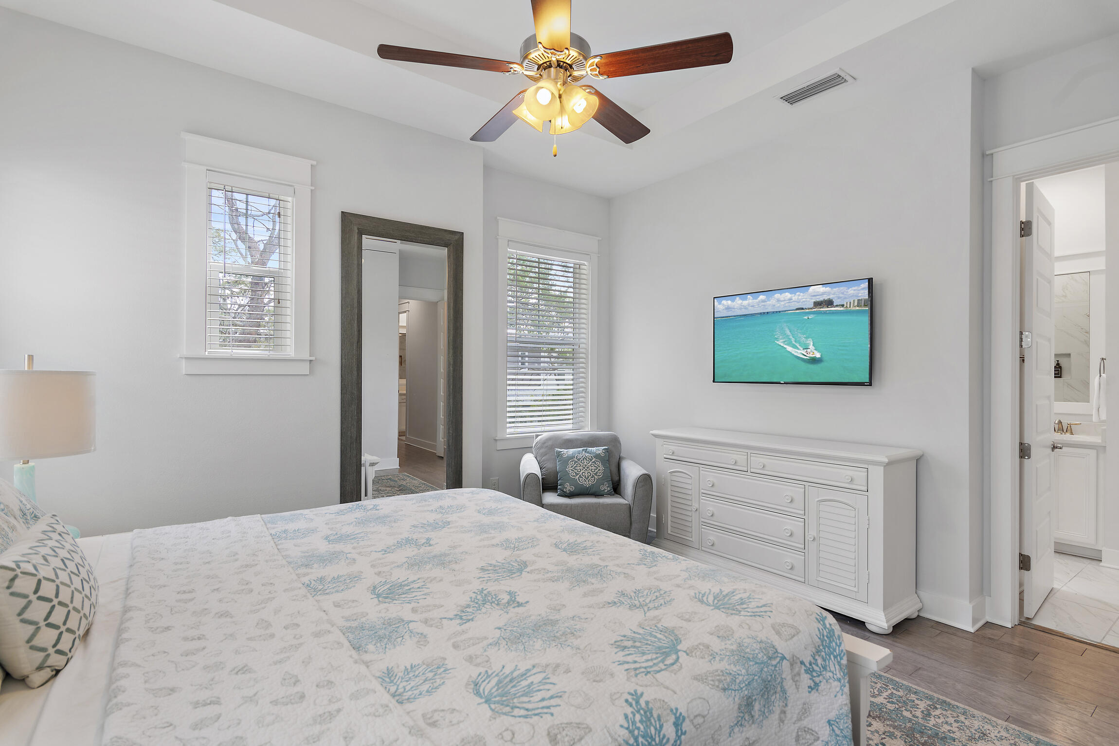 38 Pine Lands Loop East, Unit A Inlet Beach, FL 32461 - Photo 14 of 25 a bedroom with a bed and a chandelier