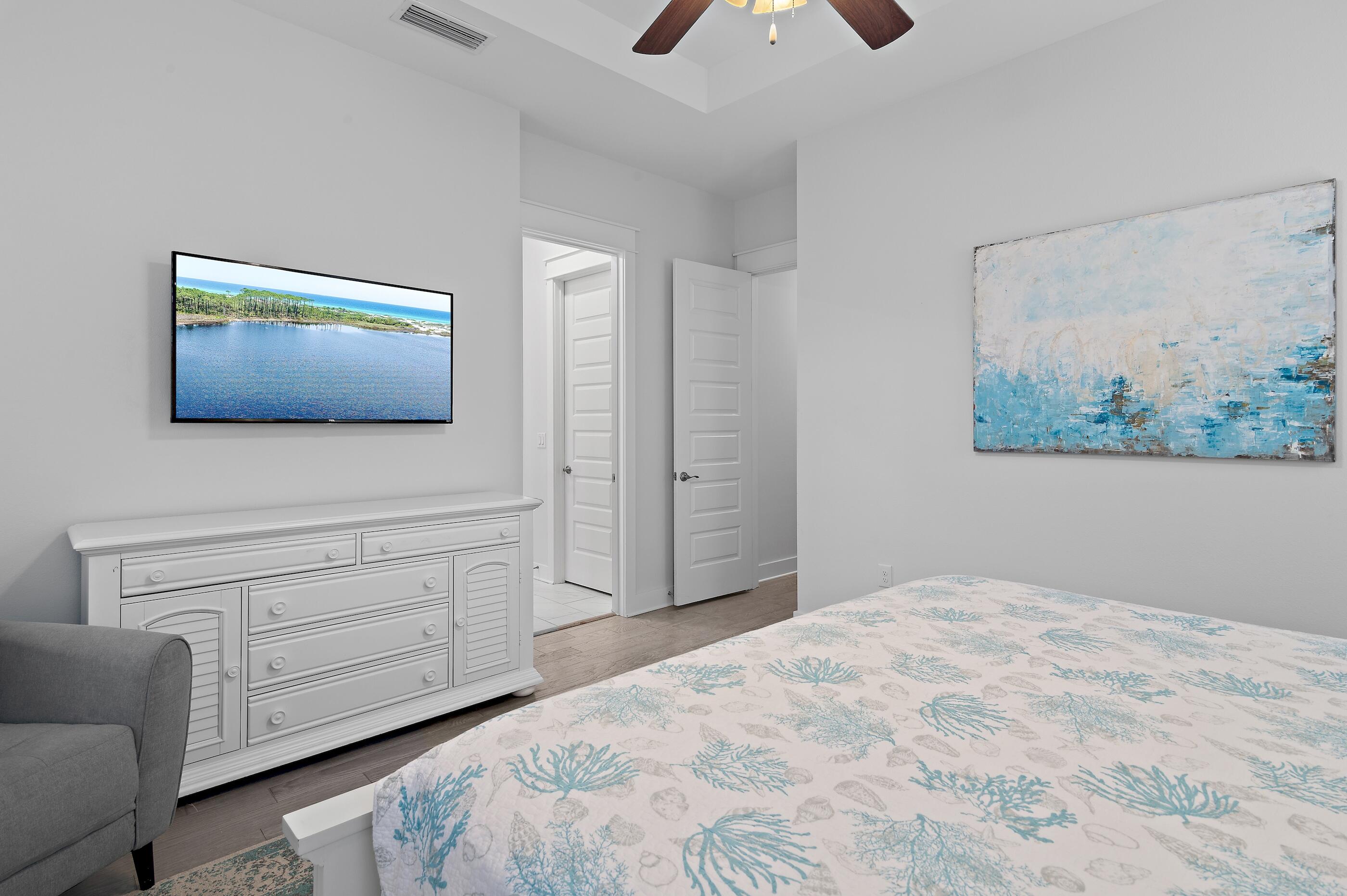38 Pine Lands Loop East, Unit A Inlet Beach, FL 32461 - Photo 15 of 25 a bedroom with a bed and a flat screen tv