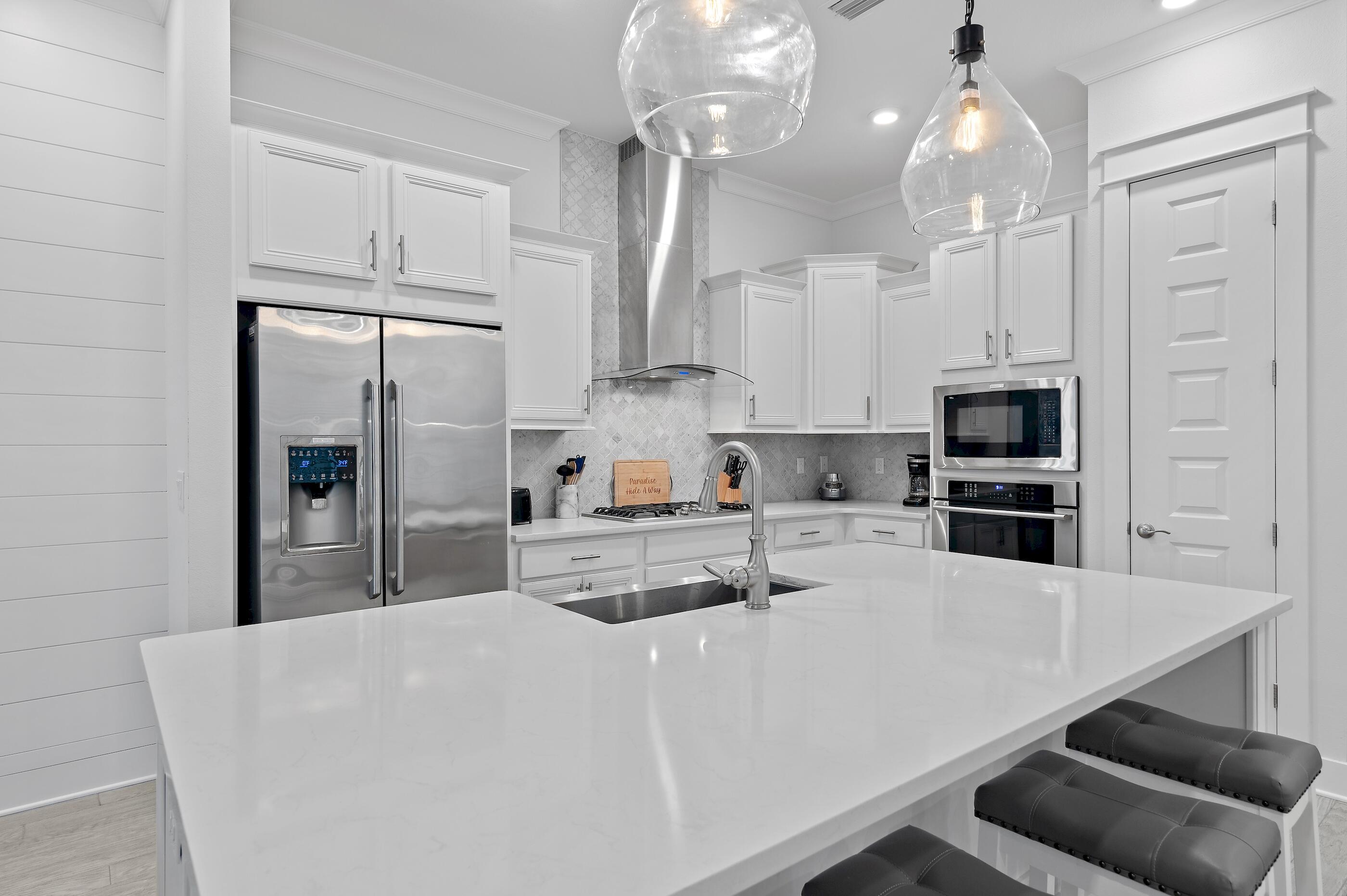 38 Pine Lands Loop East, Unit A Inlet Beach, FL 32461 - Photo 7 of 25 a kitchen with kitchen island a counter top space stainless steel appliances and cabinets