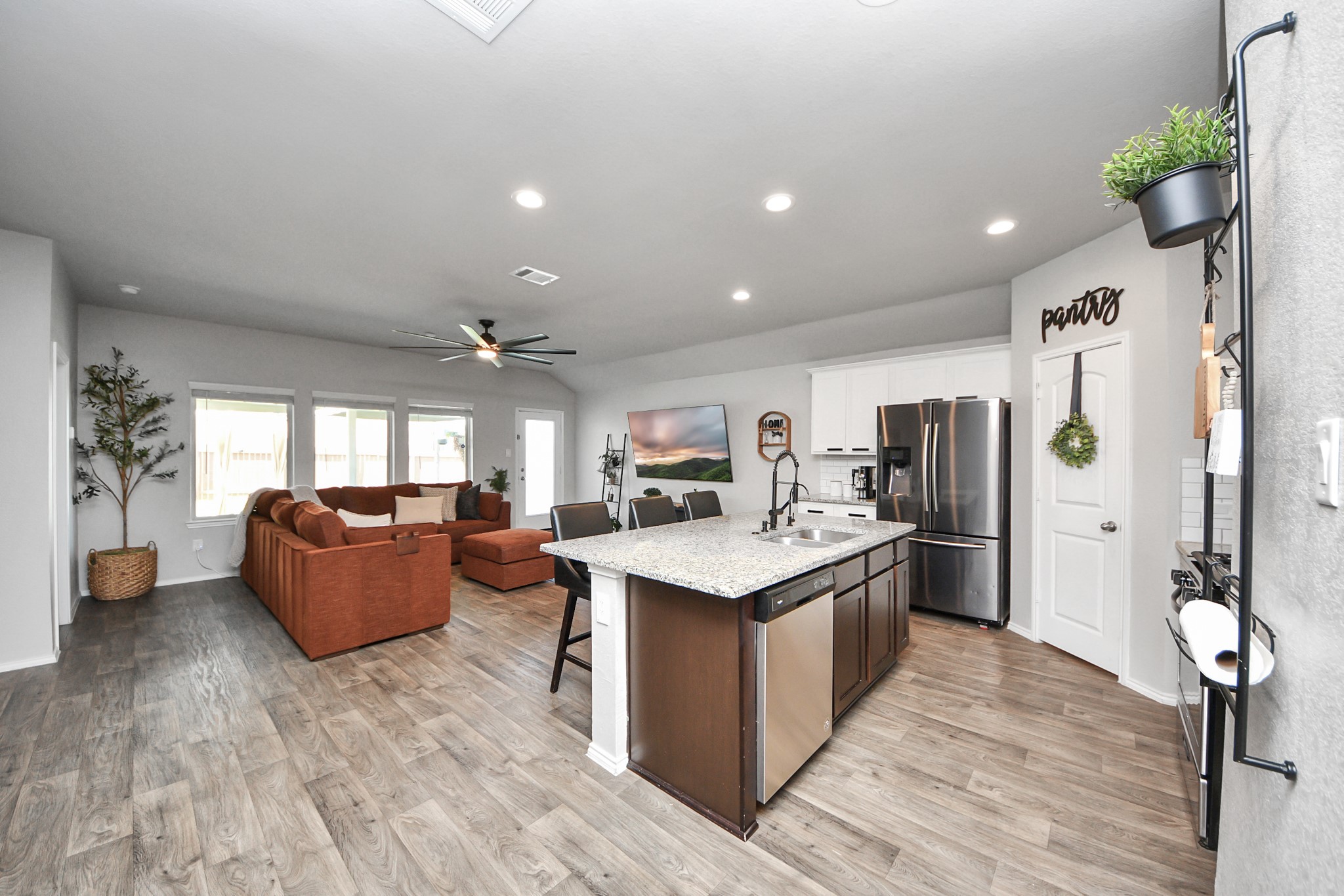 4315 Nervesa Dr. Katy, TX 77449 - Photo 15 of 41 a kitchen with stainless steel appliances granite countertop a refrigerator a sink dishwasher a stove and a dining table with wooden floor