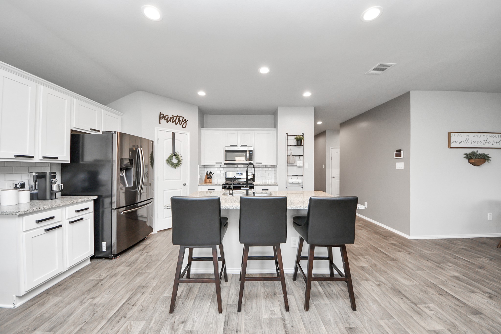 4315 Nervesa Dr. Katy, TX 77449 - Photo 17 of 41 a kitchen with a table chairs refrigerator and microwave