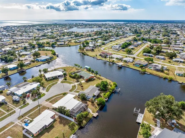 an aerial view of a house with a lake view