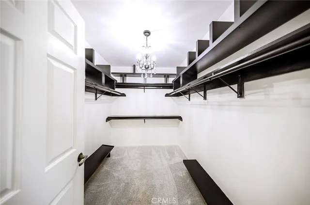 a view of a room with a refrigerator and a window