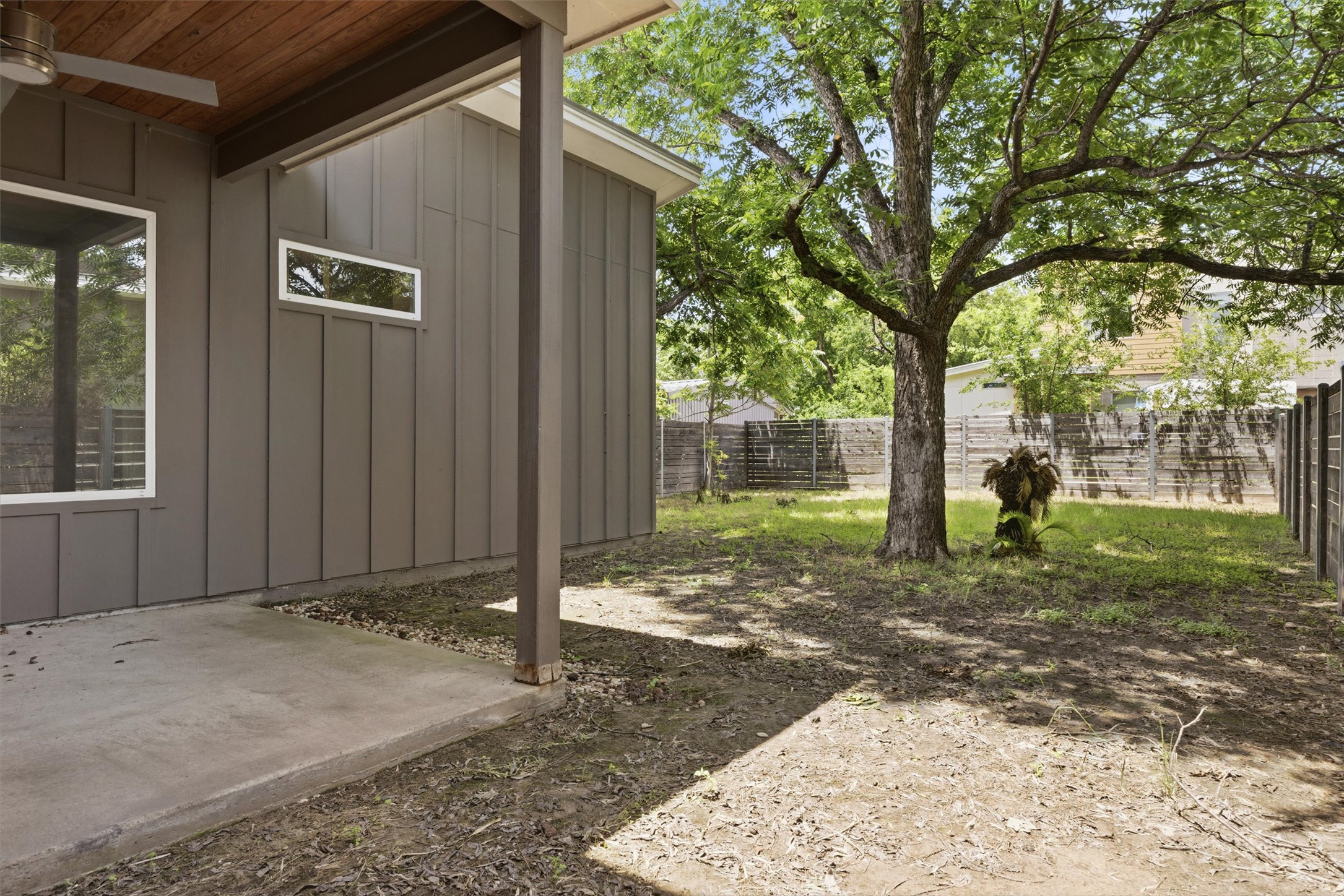 1210 Stobaugh Street, Unit B Austin, TX 78757 - Photo 4 of 40 A spacious yard with mature shade trees, offering ample room for outdoor activities and relaxation.