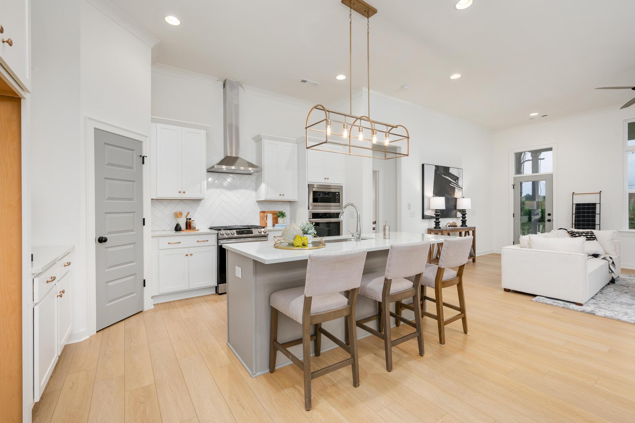 1067 Fallow Road Mount Juliet, TN 37122 - Photo 14 of 47 a kitchen with stainless steel appliances kitchen island granite countertop a table chairs and white cabinets