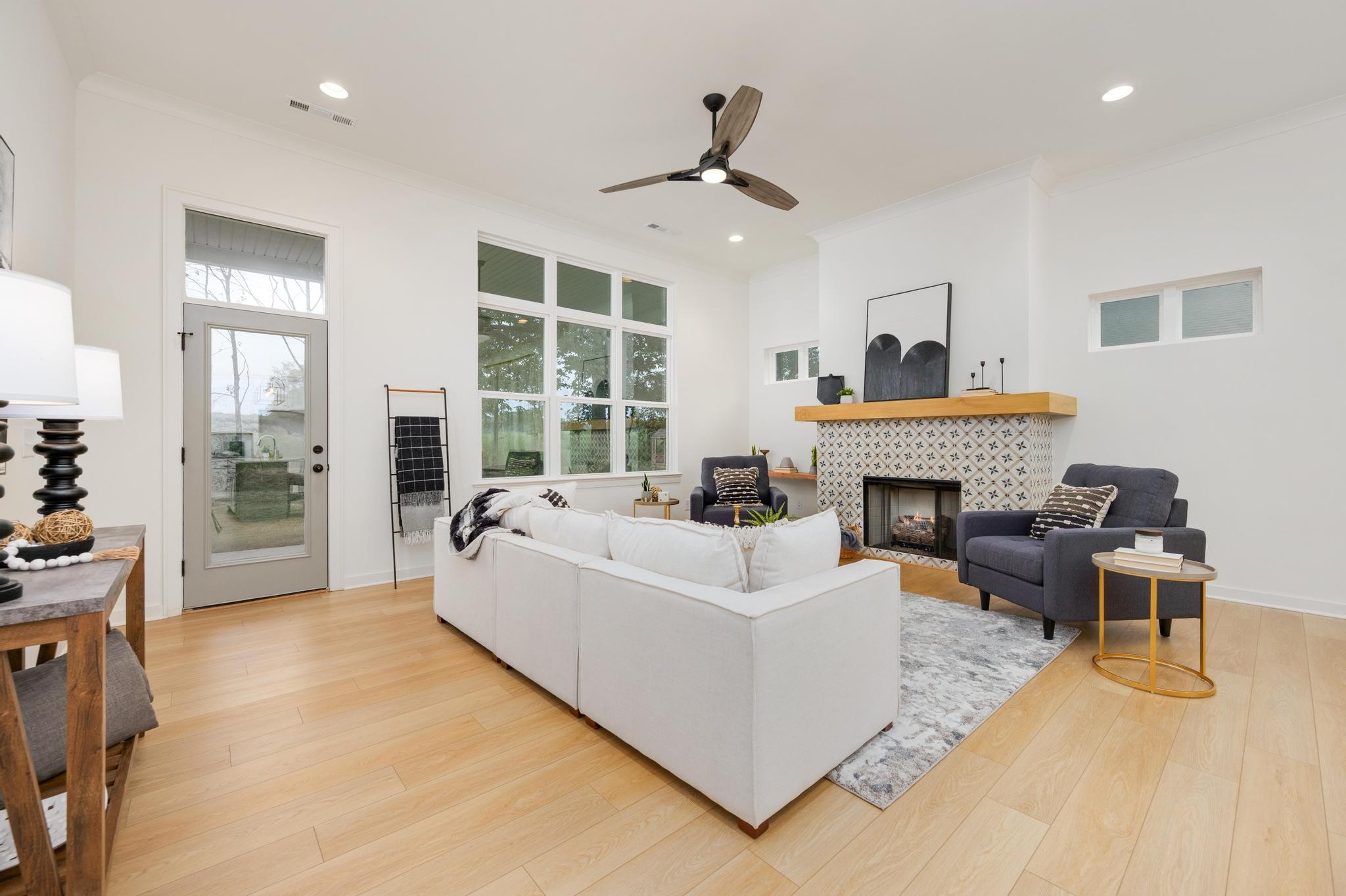 1067 Fallow Road Mount Juliet, TN 37122 - Photo 19 of 47 a living room with furniture a fireplace and a floor to ceiling window