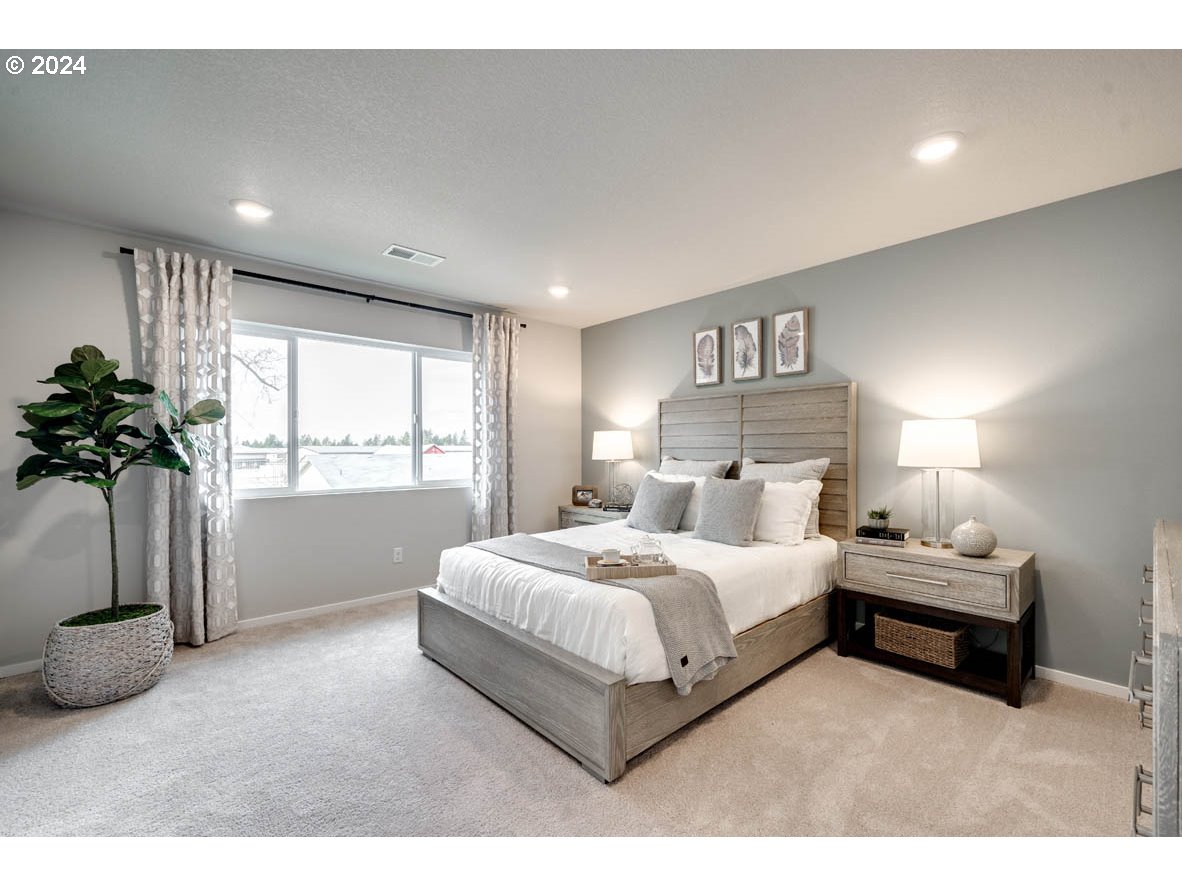 2615 U Street Springfield, OR 97477 - Photo 13 of 14 a bedroom with a large bed and a potted plant