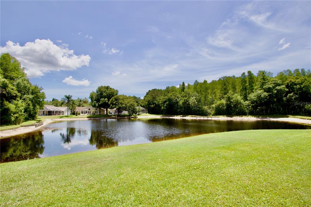 7842 Tenby Court New Port Richey, FL 34655 - Photo 19 of 27 a view of lake with houses in the back