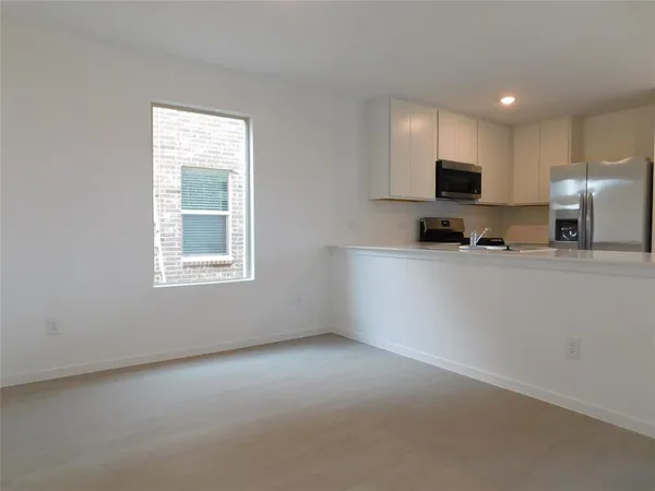 a kitchen with kitchen island a sink stainless steel appliances and cabinets