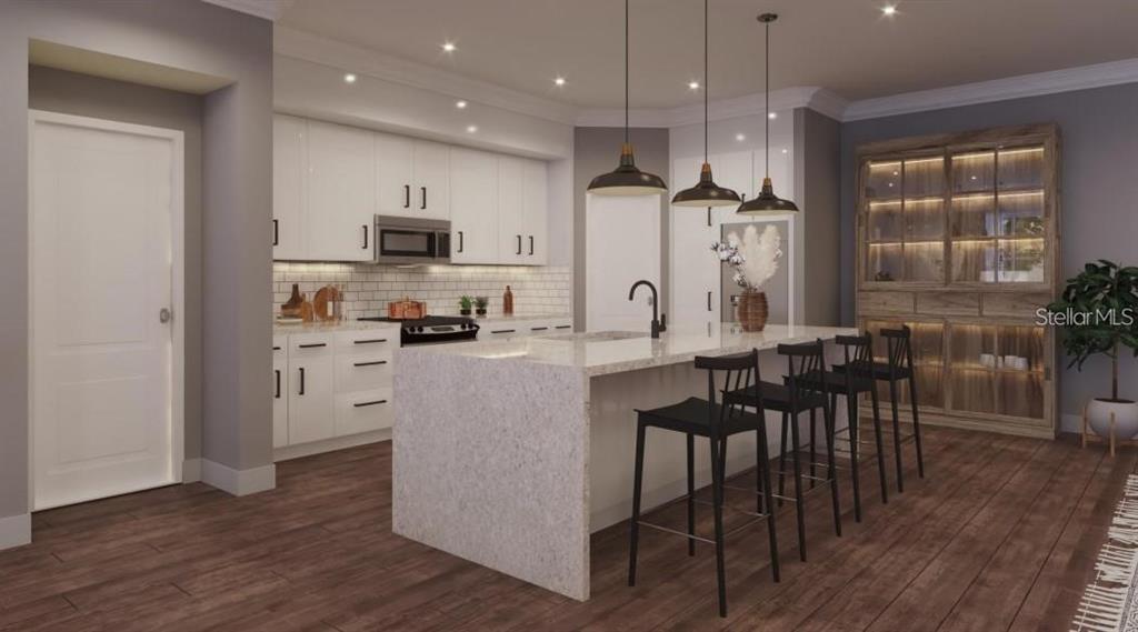 4112 Southern Valley Loop Brooksville, FL 34601 - Photo 6 of 15 an open kitchen with kitchen island wooden floor center island and stainless steel appliances