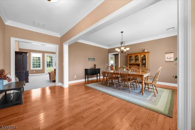 a view of a dining room with furniture and chandelier
